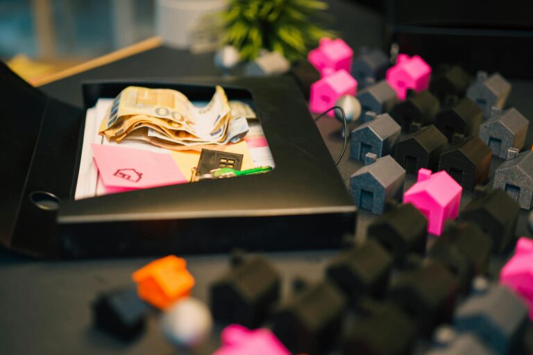 Real estate investment concept with money and house models on table.